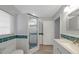Modern bathroom features tile backsplash, a shower, and bright natural light from the window at 1420 Temple St, Clearwater, FL 33756