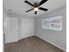 Bedroom features wood-look flooring, ceiling fan, and a large window that provides natural light at 1420 Temple St, Clearwater, FL 33756