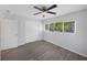 Bedroom features wood-look flooring, a ceiling fan, and a closet at 1420 Temple St, Clearwater, FL 33756