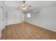 Open bedroom with ceiling fan, tile floors, closet, and modern AC wall unit at 1420 Temple St, Clearwater, FL 33756