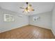 Bright bedroom with ceiling fan, tiled floors, and dual windows that let in plenty of natural light at 1420 Temple St, Clearwater, FL 33756