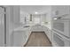 Modern kitchen featuring white cabinets, sleek countertops, and stainless steel appliances for a stylish cooking experience at 1420 Temple St, Clearwater, FL 33756