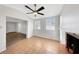 Bright room highlighting a decorative fireplace, ceiling fan, and ample natural light from the surrounding windows at 1420 Temple St, Clearwater, FL 33756