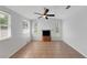 Spacious room boasting a decorative fireplace, multiple windows, and a stylish ceiling fan at 1420 Temple St, Clearwater, FL 33756