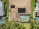An aerial view shows the screened pool and solar panels of this beautiful single Gathering home at 14228 Teasdale Ave, Hudson, FL 34667