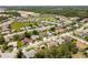 Aerial view of single Gathering homes in a beautiful community with green spaces, sidewalks, and mature landscaping at 14228 Teasdale Ave, Hudson, FL 34667