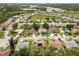 Aerial view of single Gathering homes in a beautiful community with green spaces, sidewalks, and mature landscaping at 14228 Teasdale Ave, Hudson, FL 34667