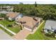 Aerial view of a house with a well-maintained lawn and mature trees, showcasing its prime location at 14228 Teasdale Ave, Hudson, FL 34667