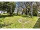 Expansive backyard with mature trees, offering a private and serene outdoor space at 14228 Teasdale Ave, Hudson, FL 34667
