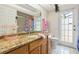 Bathroom featuring granite countertops, bright natural light and shower at 14228 Teasdale Ave, Hudson, FL 34667