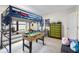 Spacious bedroom with a bunk bed over a foosball table and plenty of room for activities at 14228 Teasdale Ave, Hudson, FL 34667