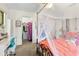 Bright bedroom featuring a four-poster bed and a view of the walk-in closet and desk area at 14228 Teasdale Ave, Hudson, FL 34667