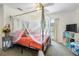 Inviting bedroom with canopy bed, soft lighting, and access to the pool area at 14228 Teasdale Ave, Hudson, FL 34667