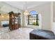 Bright dining room featuring a large arched window and elegant chandelier at 14228 Teasdale Ave, Hudson, FL 34667