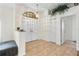 Elegant foyer with tile flooring, high ceilings, chandelier, and double-door entry at 14228 Teasdale Ave, Hudson, FL 34667