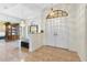 Bright foyer featuring tile floors, chandelier, a mirrored wall and double doors at 14228 Teasdale Ave, Hudson, FL 34667