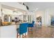 Open kitchen features stainless steel appliances, granite countertops, and breakfast bar seating at 14228 Teasdale Ave, Hudson, FL 34667