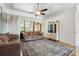 Spacious living room with sliding glass doors to lanai and an oriental rug at 14228 Teasdale Ave, Hudson, FL 34667