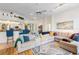Open concept living room with kitchen view, showcasing modern decor and bright, natural light at 14228 Teasdale Ave, Hudson, FL 34667