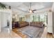 Cozy living room featuring a tray ceiling, large rug, sofas, and mirrored wall at 14228 Teasdale Ave, Hudson, FL 34667