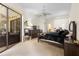 Spacious main bedroom featuring neutral carpeting, ceiling fan, and sliding glass doors to the lanai at 14228 Teasdale Ave, Hudson, FL 34667