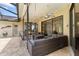 Relaxing outdoor patio featuring tile flooring, ceiling fans, and a comfortable wicker seating area at 14228 Teasdale Ave, Hudson, FL 34667