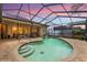 Beautiful backyard pool with screened enclosure and colorful sunset views at 14228 Teasdale Ave, Hudson, FL 34667