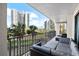 Balcony area with patio furniture, offering a scenic view of tropical surroundings and ocean view at 1501 Gulf Blvd # 201, Clearwater Beach, FL 33767