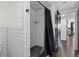 Modern bathroom featuring a subway-tiled shower with sleek black fixtures and a pebble stone floor at 1501 Gulf Blvd # 201, Clearwater Beach, FL 33767