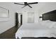 Light and airy bedroom features wood-look floors, a ceiling fan, and doors to the ensuite bath and closet at 1501 Gulf Blvd # 201, Clearwater Beach, FL 33767