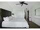 Bright bedroom features wood-look floors, a ceiling fan, a large bed, and a walk-in closet at 1501 Gulf Blvd # 201, Clearwater Beach, FL 33767