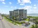 Exterior showcases lush tropical landscaping and palm trees with ocean views, creating an inviting atmosphere at 1501 Gulf Blvd # 201, Clearwater Beach, FL 33767