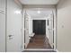 Hallway featuring hardwood floors, seating, and closet space, creating an organized and stylish transition at 1501 Gulf Blvd # 201, Clearwater Beach, FL 33767