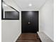 Entryway features dark wood flooring, a modern wall mirror, and double door entry at 1501 Gulf Blvd # 201, Clearwater Beach, FL 33767