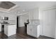 Open kitchen featuring modern appliances, white cabinetry, and a view into the living area and dining space at 1501 Gulf Blvd # 201, Clearwater Beach, FL 33767