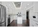 Bright and airy kitchen with white cabinets, stainless steel appliances, and a convenient center island at 1501 Gulf Blvd # 201, Clearwater Beach, FL 33767