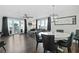 Open floor plan with water views, featuring a modern dining set and a comfortable living room area at 1501 Gulf Blvd # 201, Clearwater Beach, FL 33767