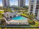 Aerial view of the pool area, showcasing the deck, lounge chairs, and ocean views at 1501 Gulf Blvd # 201, Clearwater Beach, FL 33767