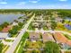 Aerial view of the neighborhood featuring houses, streets, lakes, and green landscape at 17342 Lawn Orchid Loop, Land O Lakes, FL 34638