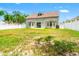 Spacious backyard with green grass, a white fence, and the exterior of the home at 17342 Lawn Orchid Loop, Land O Lakes, FL 34638