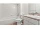 Cozy bathroom features a shower-tub combo, tile floors, vanity, and sink at 17342 Lawn Orchid Loop, Land O Lakes, FL 34638