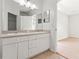 Bathroom featuring double sinks, neutral decor, and white cabinets at 17342 Lawn Orchid Loop, Land O Lakes, FL 34638