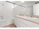 Bathroom featuring double sinks, a bathtub, and tiled walls at 17342 Lawn Orchid Loop, Land O Lakes, FL 34638