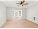Bedroom showcasing a ceiling fan, window seat, and wood-look flooring at 17342 Lawn Orchid Loop, Land O Lakes, FL 34638
