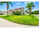 Beautiful single-Gathering home with a lush green lawn and mature trees, offering a serene setting at 17342 Lawn Orchid Loop, Land O Lakes, FL 34638