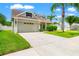 Lovely home featuring an attached two-car garage and meticulous landscaping, showcasing great curb appeal at 17342 Lawn Orchid Loop, Land O Lakes, FL 34638