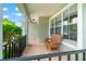 Cozy front porch with brick flooring, black railing, and wicker chair, perfect for relaxing outdoors at 17342 Lawn Orchid Loop, Land O Lakes, FL 34638