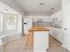 Open-concept kitchen featuring stainless steel appliances and a breakfast bar at 17342 Lawn Orchid Loop, Land O Lakes, FL 34638