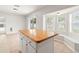 Bright kitchen area featuring an island and sliding glass doors to the back yard at 17342 Lawn Orchid Loop, Land O Lakes, FL 34638