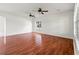 Spacious living room featuring hardwood floors, two ceiling fans, and lots of natural light at 17342 Lawn Orchid Loop, Land O Lakes, FL 34638